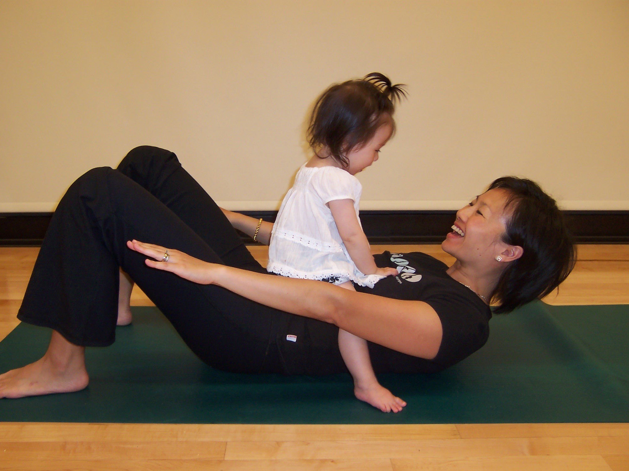 Woman doing yoga with toddler