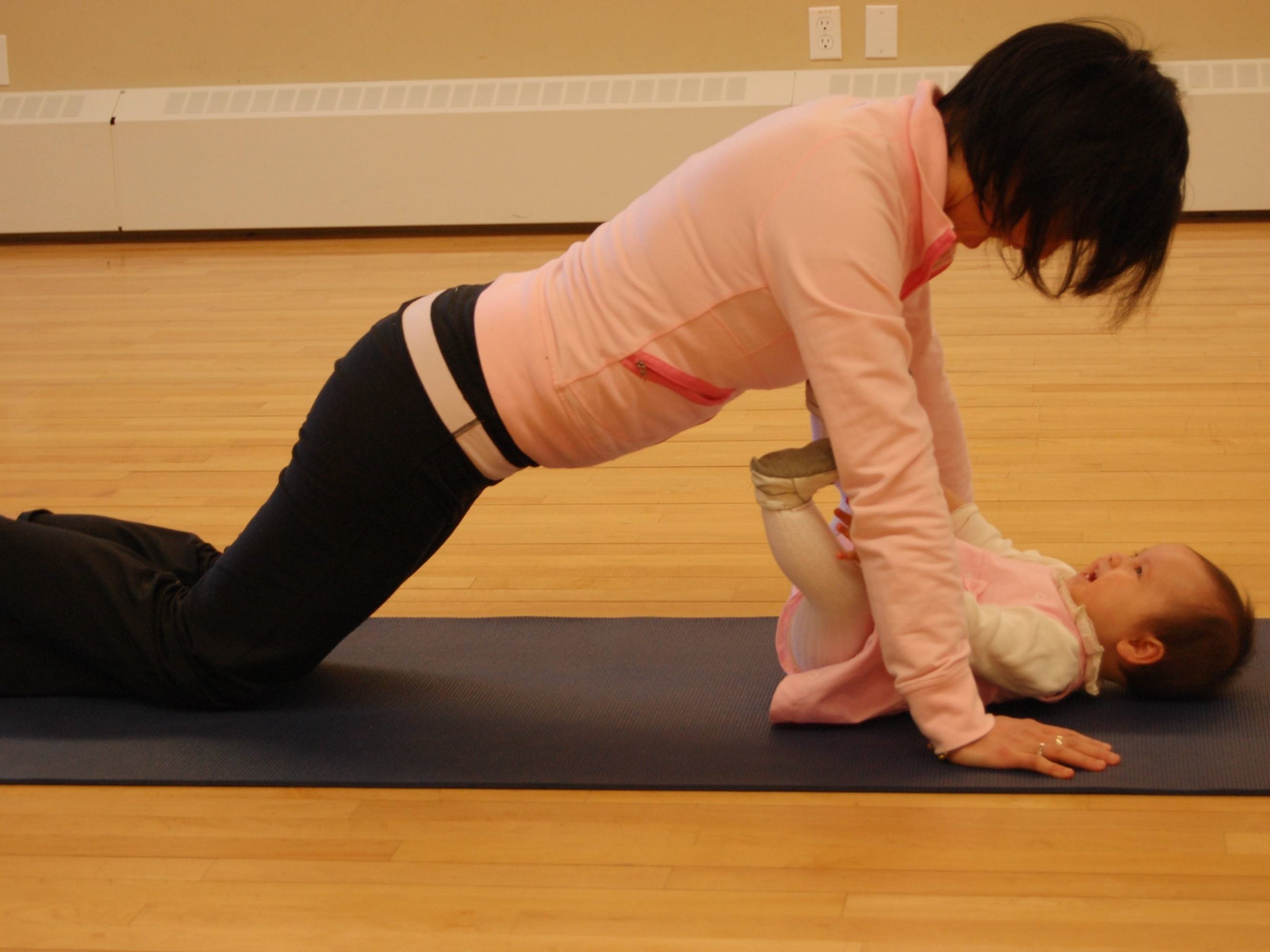 Woman doing yoga with baby