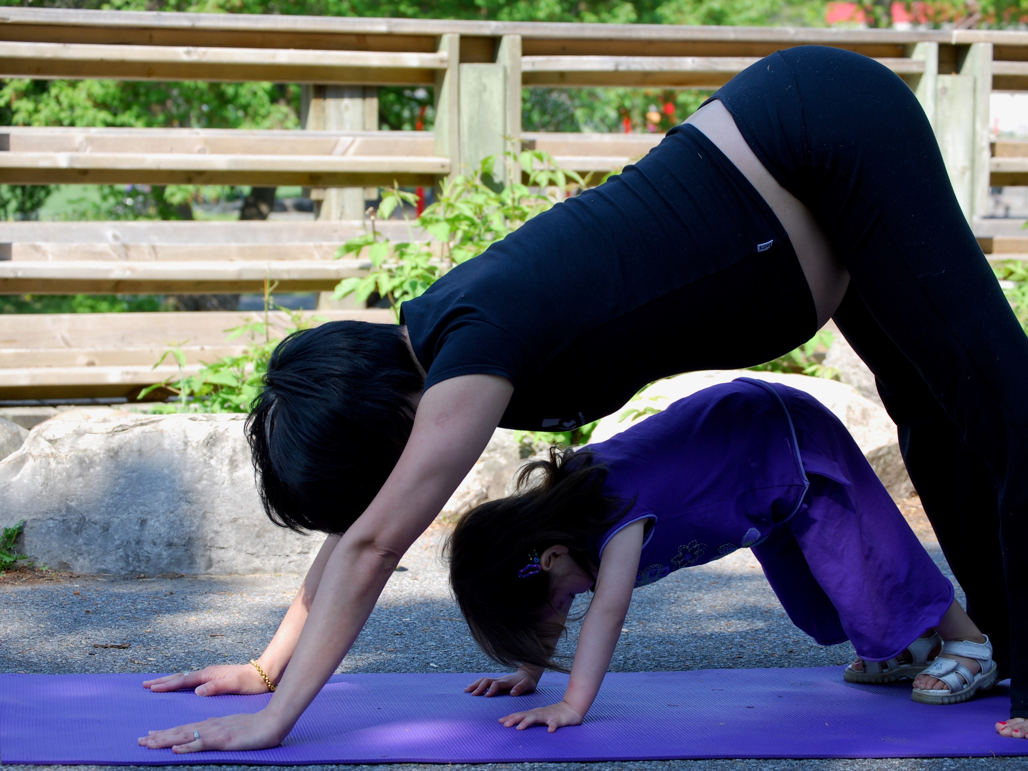 Woman doing yoga with toddler